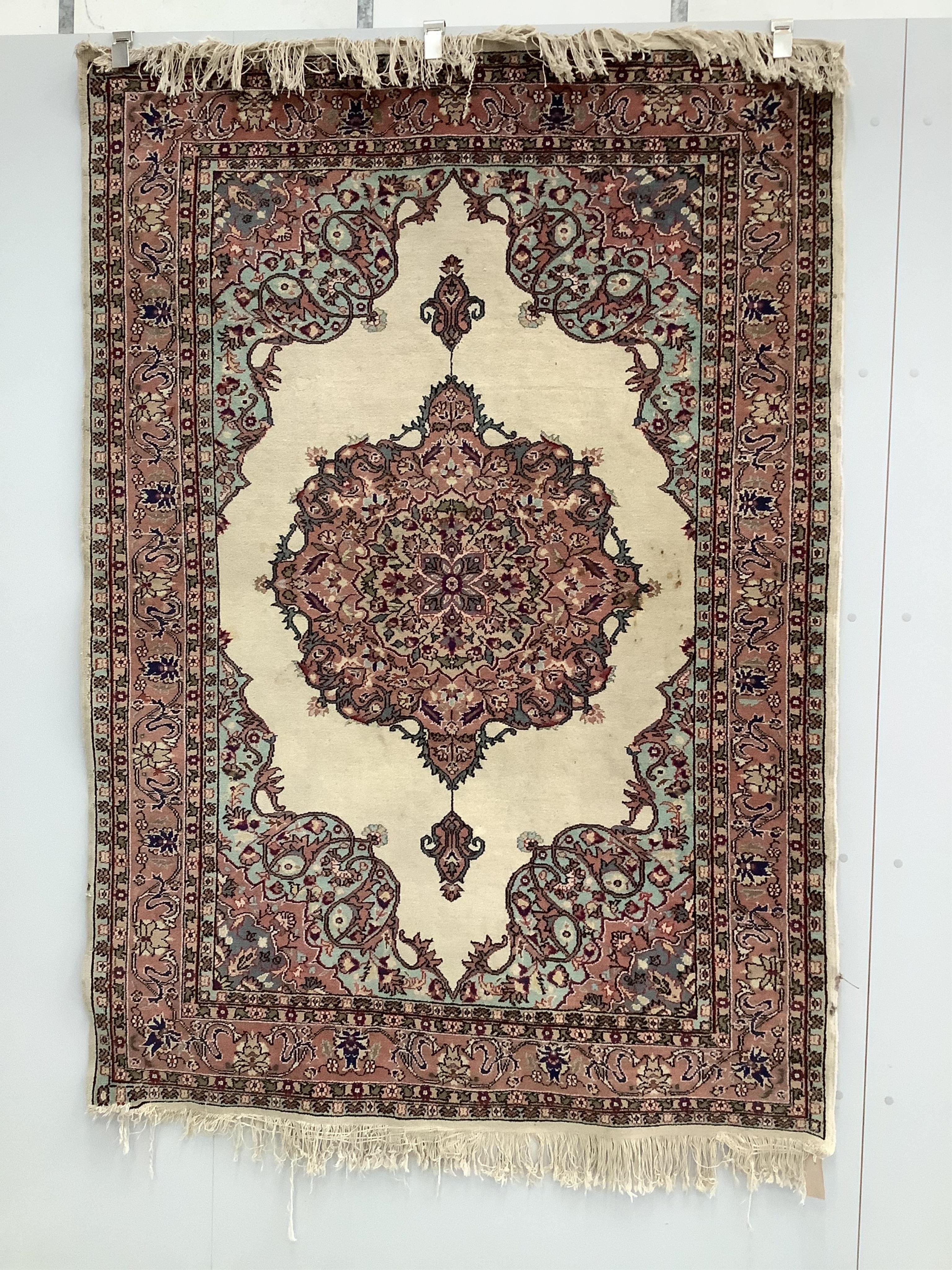 A Turkish ivory ground rug and a similar smaller red ground rug, larger 194 x 141cm. Condition - fair